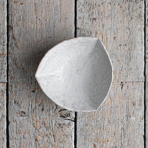 Organic Triangular ceramic snack bowl with a hand-moulded organic shape, designed as a minimalist serving piece for chips, crackers, and shared appetizers. Shot from above